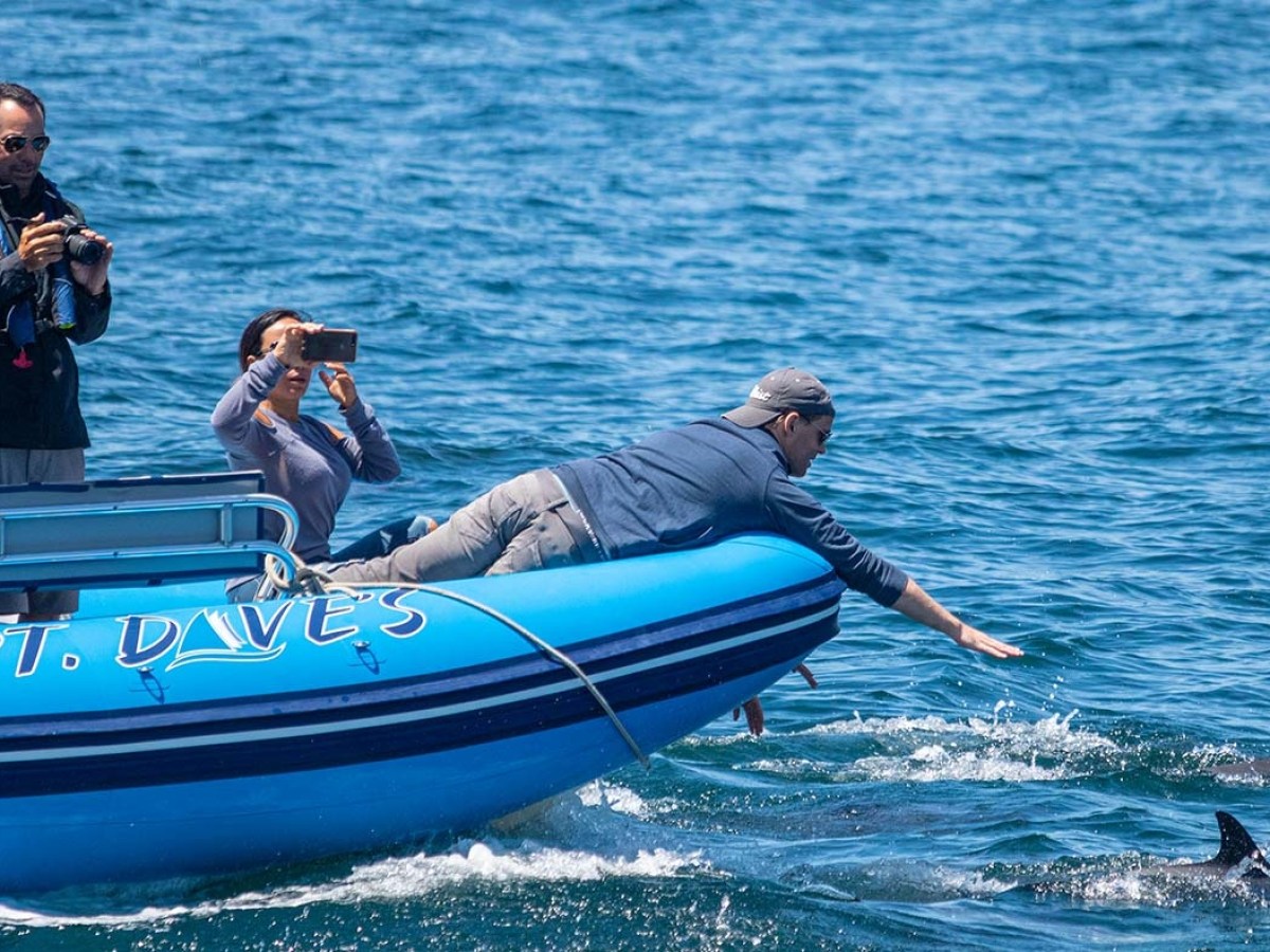 a person riding on the back of a boat in a body of water